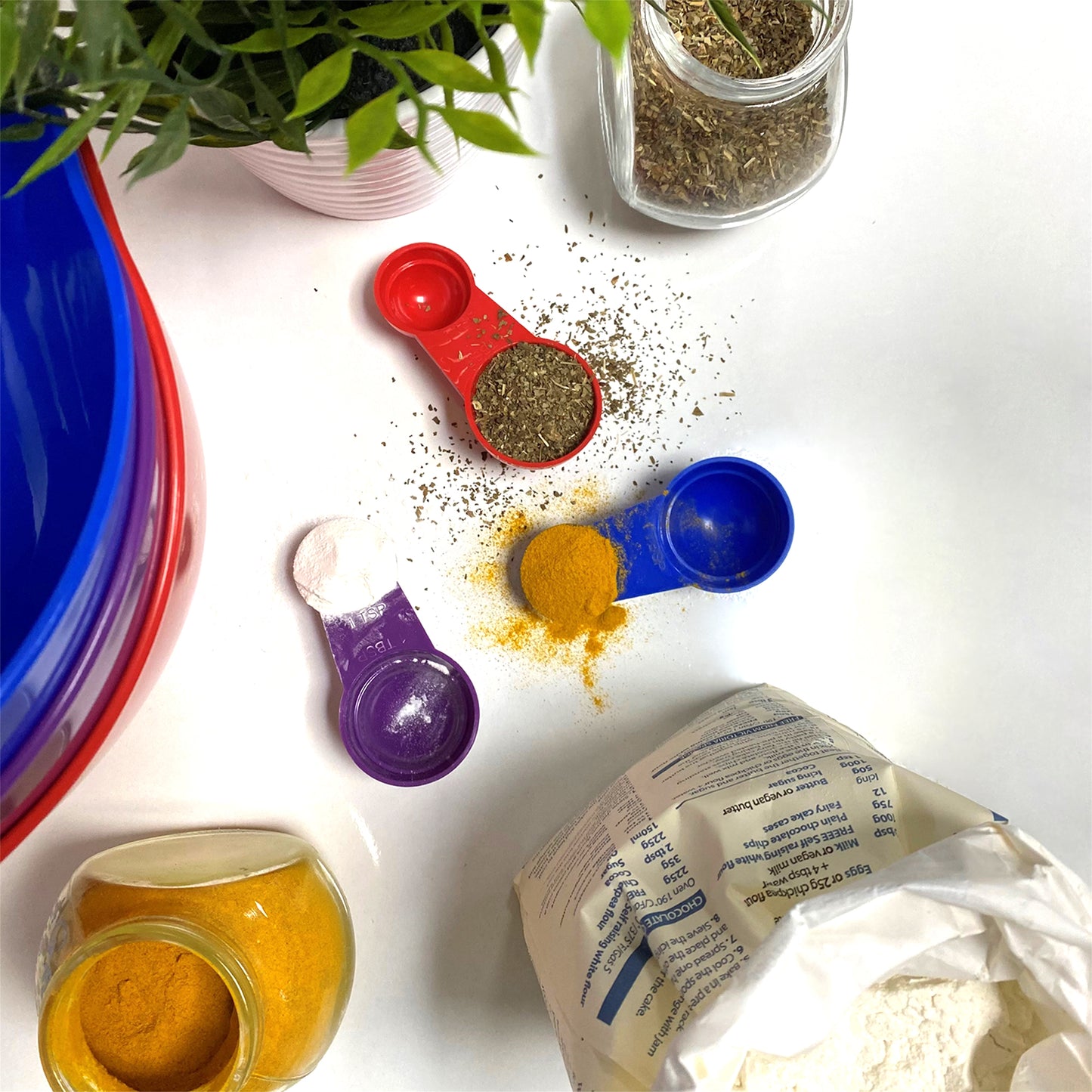 red, purple and dark blue plastic measuring spoons set for measuring ingredients
