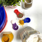 red, purple and dark blue plastic  measuring spoons set for measuring ingredients